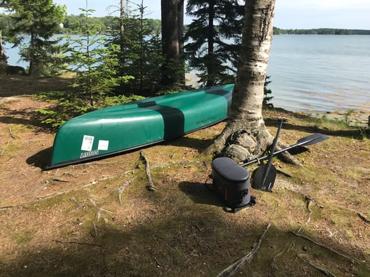 Scout canoe by water